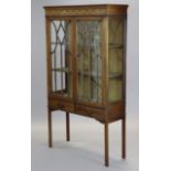 An Edwardian inlaid-mahogany standing display cabinet with glazed sides, fitted two shelves enclosed