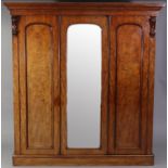 A Victorian hanging mahogany wardrobe, with moulded cornice, enclosed by centre mirror door, a panel