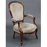 A Victorian mahogany frame spoon-back elbow chair, with padded seat, back & arms upholstered light