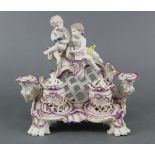 An 18th century Ludwigsburg porcelain inkstand, with puce & gilt decoration surmounted by two