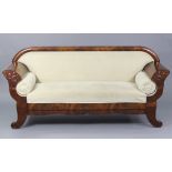 A 19th century flame mahogany sofa upholstered cream velour, with rounded back, foliate carved