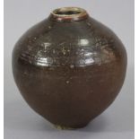 A large dark-brown glazed ovoid pottery jar, possibly Chinese Ming dynasty, with short neck, the