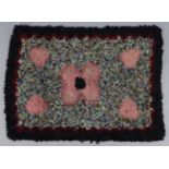 A traditional rag rug (probably early 20thC), with central poppy design on a multicoloured