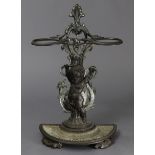 A Victorian cast-iron umbrella stand of pierced foliate design supported by a putto & dragon, on