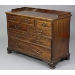 A Georgian style mahogany low tray-top chest, fitted an arrangement of seven drawers with brass