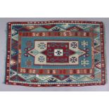 A Kelim rug of crimson, turquoise, & cream ground with central medallion in multiple geometric