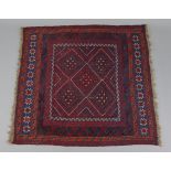 A Kazak rug of crimson & deep blue ground, with central panel of five lozenges flanked by two star