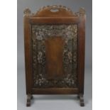 An Anglo-Indian hardwood firescreen, profusely carved & pierced with scrolling foliage around a