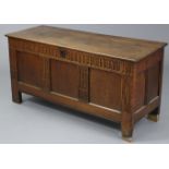 A late 17th/early 18th century carved oak coffer, with three-panel front intersected by stop-