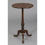 A Georgian mahogany tripod table with moulded edge to the circular top on a vase-turned column &