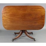 A regency mahogany breakfast table, the rectangular one-piece tilt-top with plain edge, on ring-