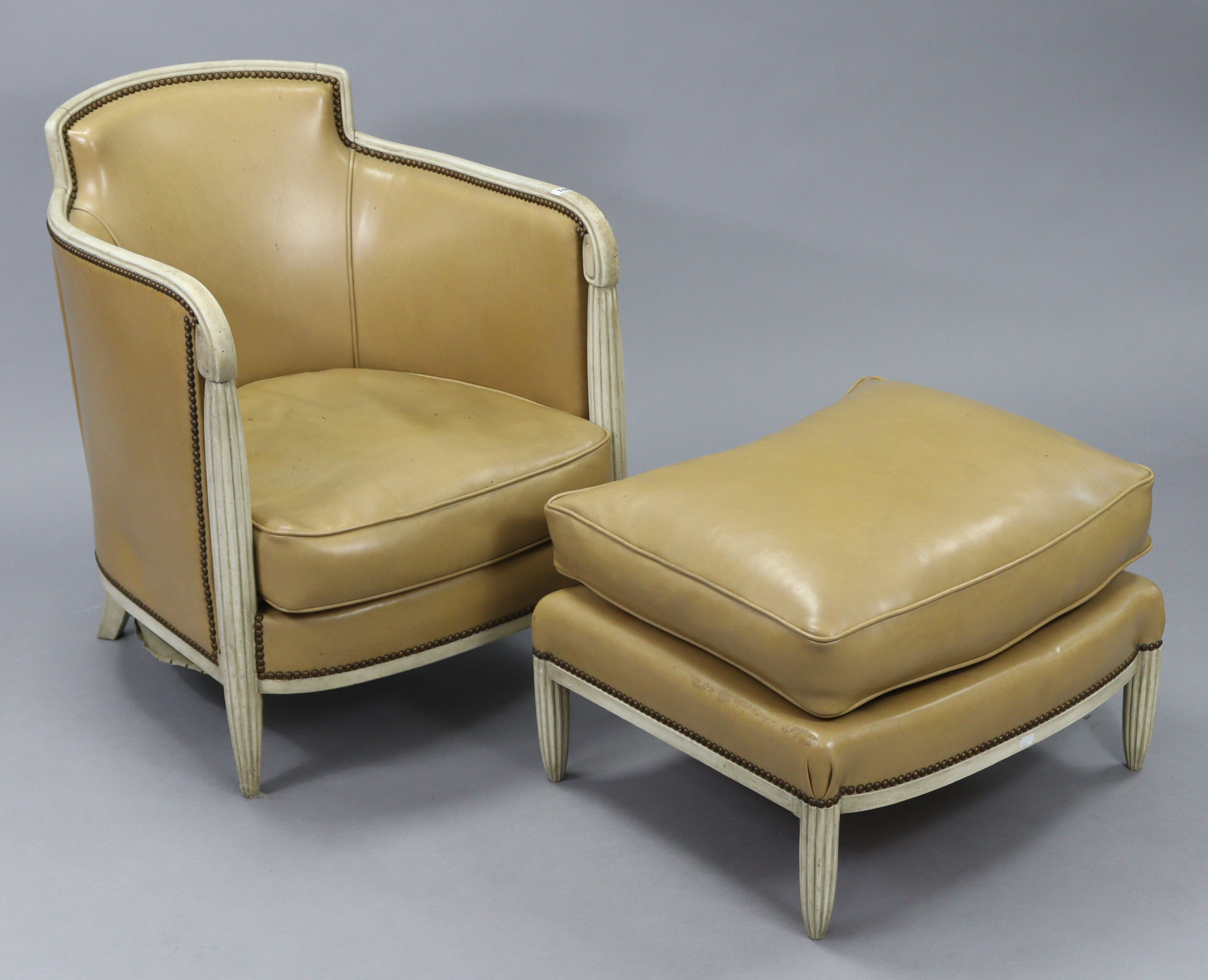 A cream-finish wooden frame tub-shaped easy chair in the 19th century continental style, upholstered
