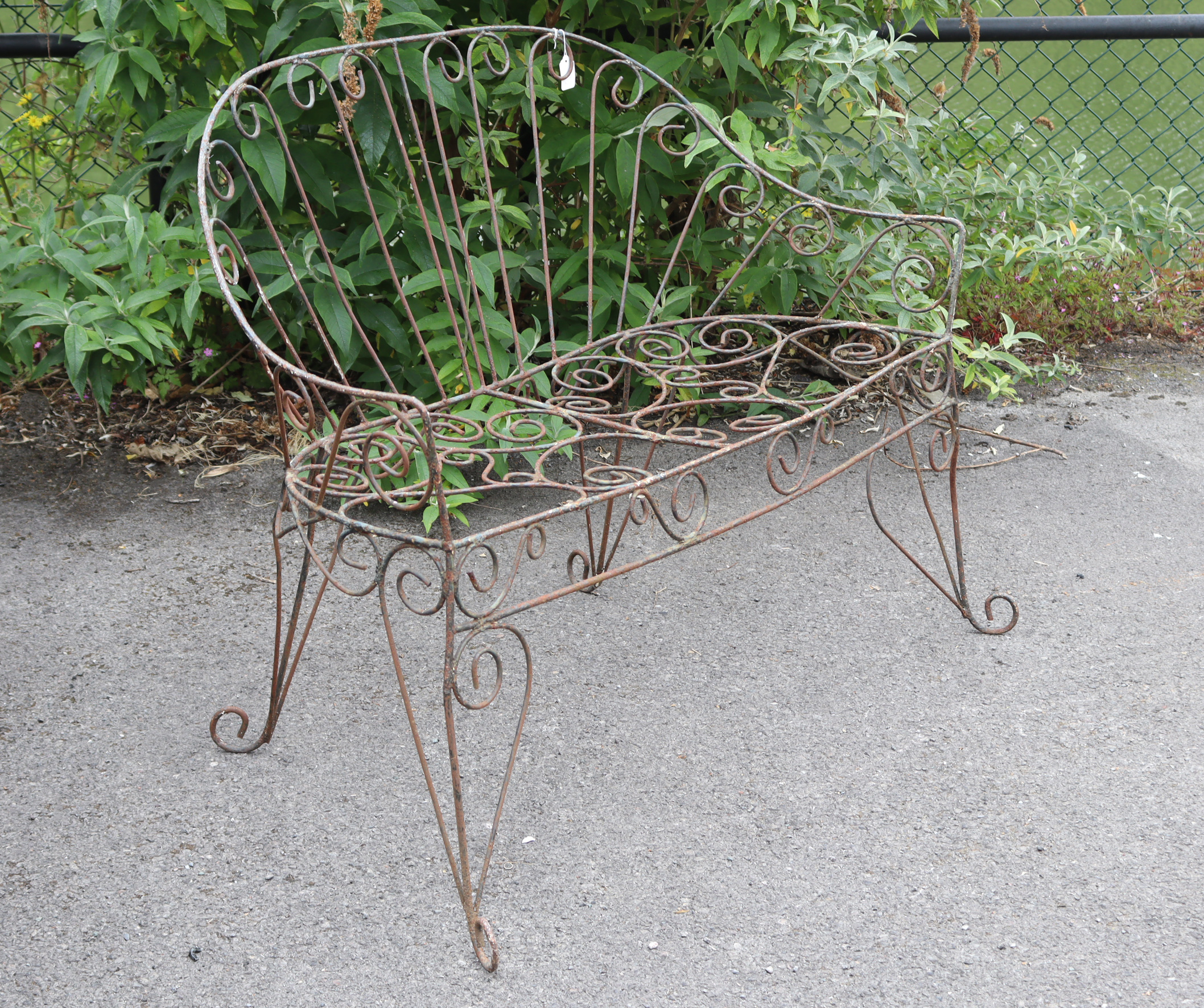 A Victorian-style wrought-iron two-seater garden bench with pierced scroll decoration, & on shaped - Image 3 of 7