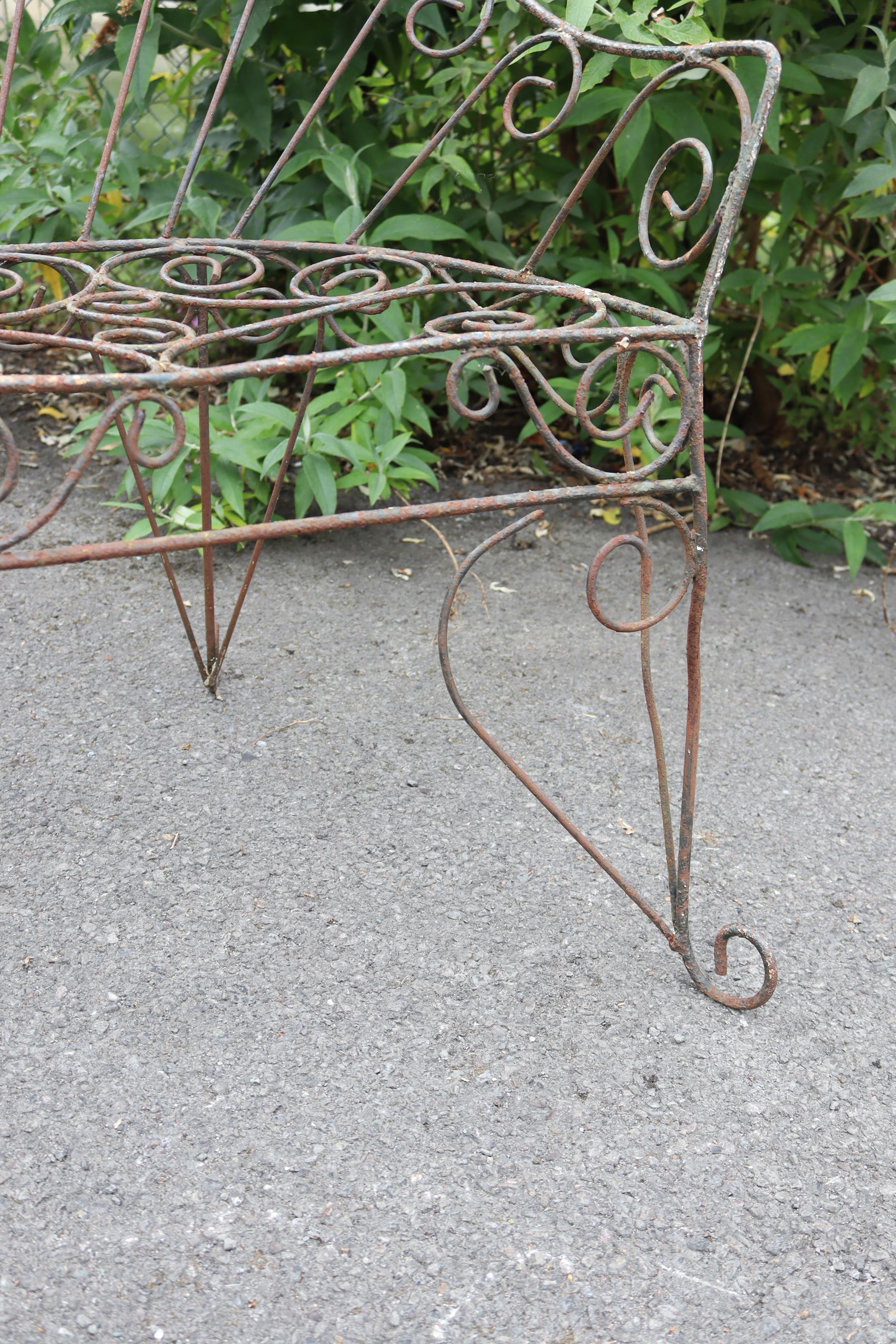 A Victorian-style wrought-iron two-seater garden bench with pierced scroll decoration, & on shaped - Image 7 of 7