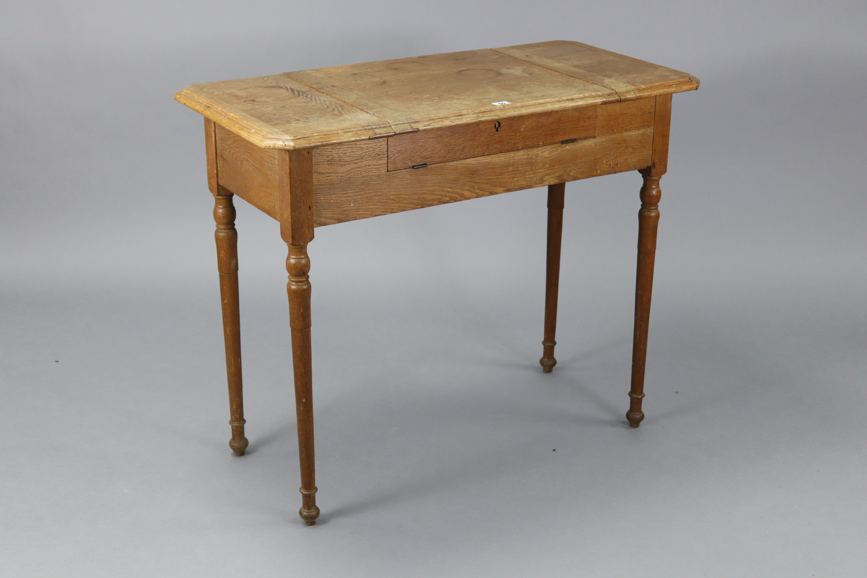 An Edwardian oak writing table with fitted interior enclosed by three hinged panels, & on turned - Image 5 of 7