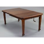 An Edwardian mahogany extending dining table with canted corners to the rectangular top, with centre