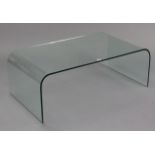 A contemporary glass low coffee table with rounded ends to the rectangular top, 43” wide x 15½” high