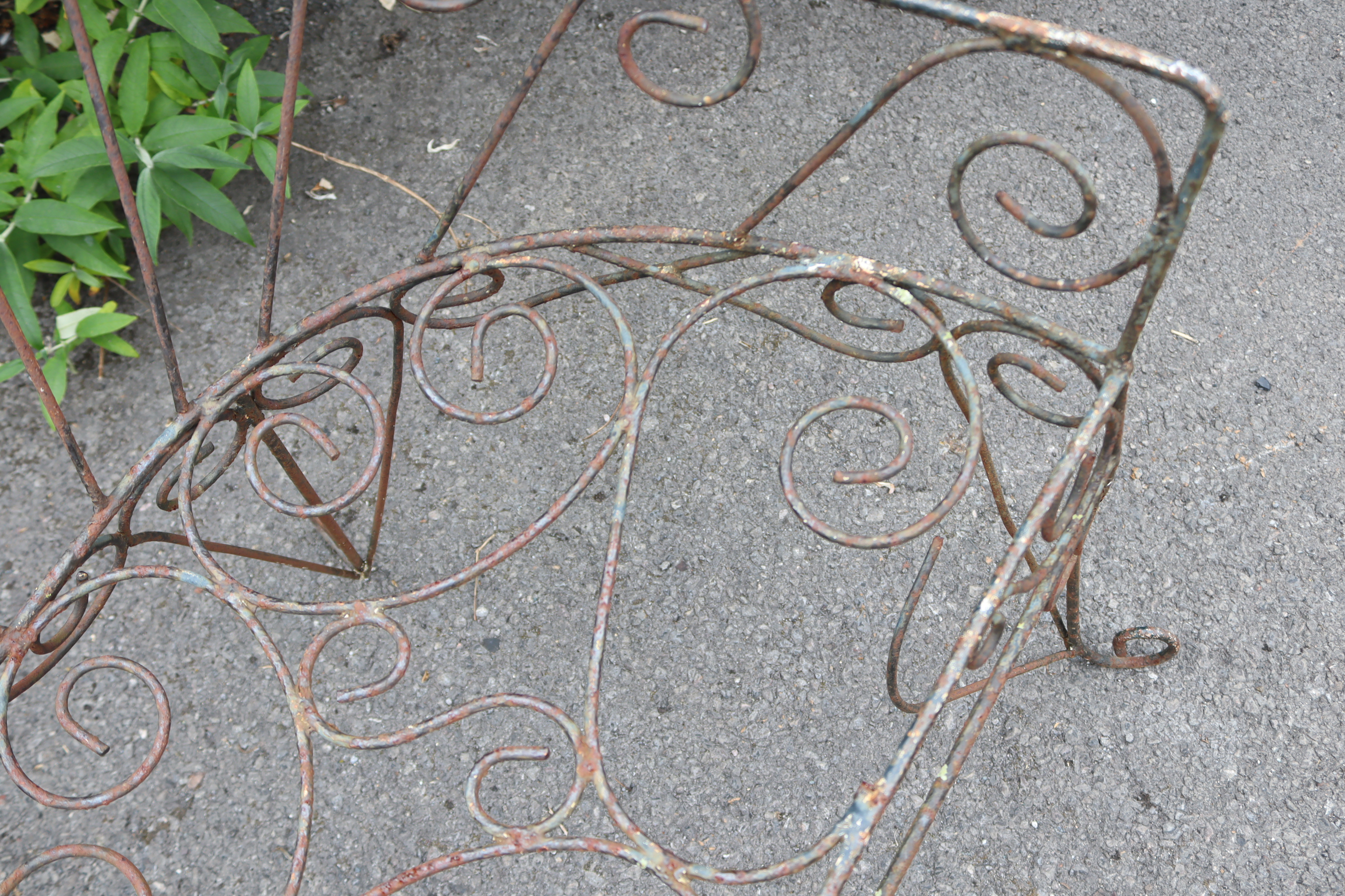 A Victorian-style wrought-iron two-seater garden bench with pierced scroll decoration, & on shaped - Image 6 of 7