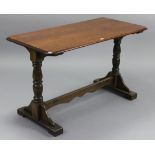 An oak dining table with moulded edge & rounded corners to the rectangular top, & on baluster-turned