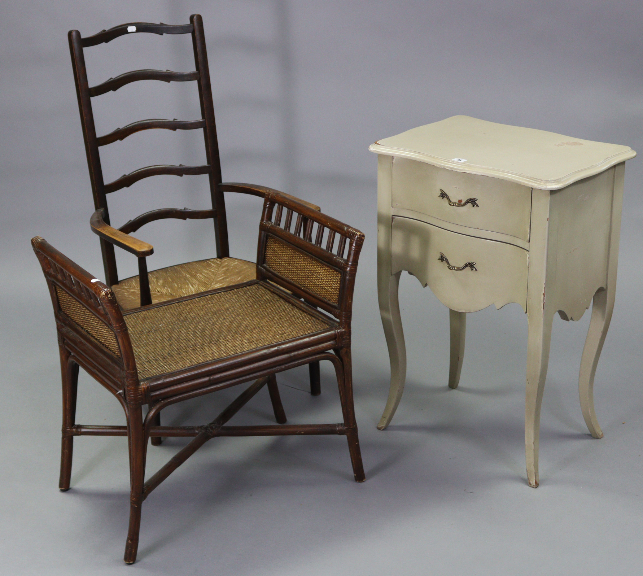 A cream-finish serpentine-front bedside chest fitted two long graduated drawers, & on slender