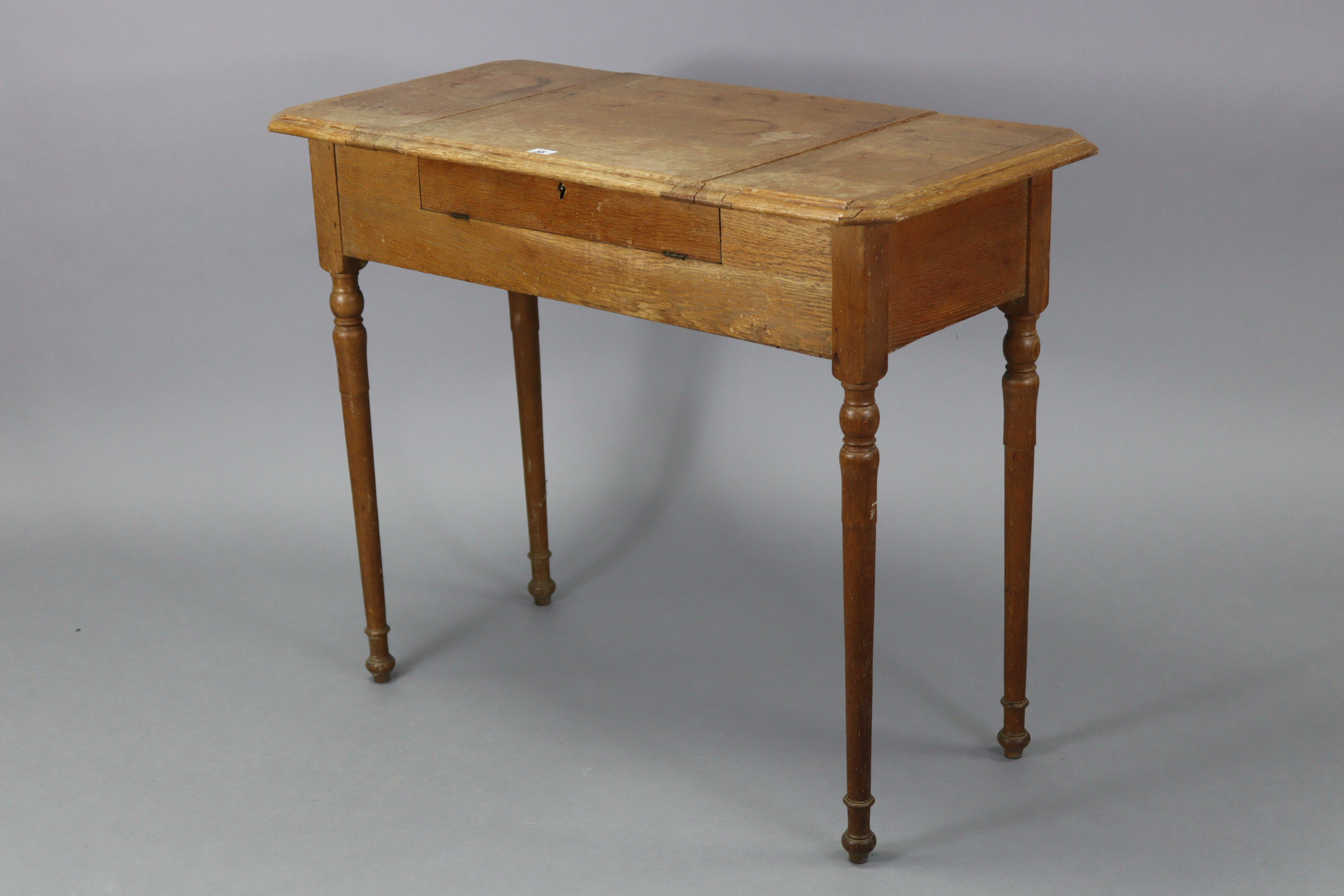 An Edwardian oak writing table with fitted interior enclosed by three hinged panels, & on turned - Image 6 of 7