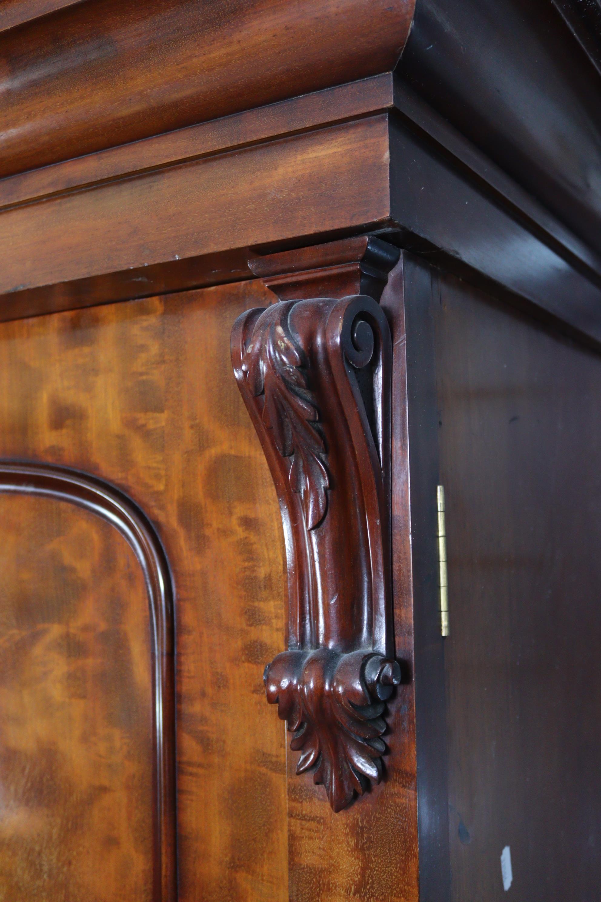 A Victorian hanging mahogany wardrobe with moulded cornice, enclosed centre mirror door, a panel - Image 5 of 9