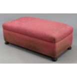 An early 20th century pine box-ottoman upholstered pink floral damask, with hinged lift-lid, & on