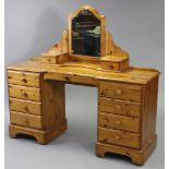 A modern pine kneehole dressing table, fitted four drawers to either end & with a centre frieze