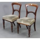 A pair of Victorian mahogany balloon-back dining chairs, each with carved & shaped centre rail,