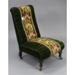 A late 19th century nursing chair upholstered green velour & multi-coloured foliate embroidery, on