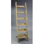 A light oak tall six-tier lean-to shelf unit, 18¾” wide x 71” high.