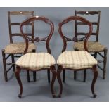 A pair of Victorian-style balloon-back dining chairs with padded seats, & on slender cabriole