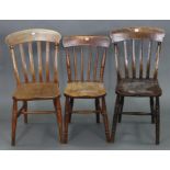 A pair of lath-back kitchen chairs with hard seats, & on turned legs with spindle stretchers; & a