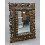 A 17th century-style rectangular wall mirror inset bevelled plate, & in a carved & pierced wooden