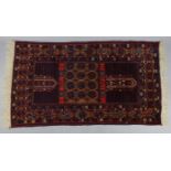 A Persian rug of crimson & fawn ground with central rectangular panel in multiple geometric borders;