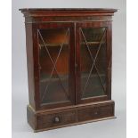 An early 20th century small mahogany bookcase, fitted two shelves enclosed by pair of glazed doors