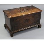 A small oak coffer with carved decoration to the hinged lift-lid & front, & on carved bracket