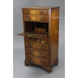 A reproduction mahogany small upright secretaire chest fitted with an arrangement of seven