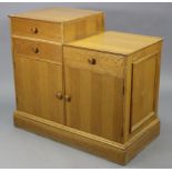 An aesthetic style light oak side cabinet, fitted with an arrangement of three drawers above