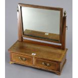 An Edwardian inlaid mahogany rectangular swing toilet glass, fitted two small drawers to the box