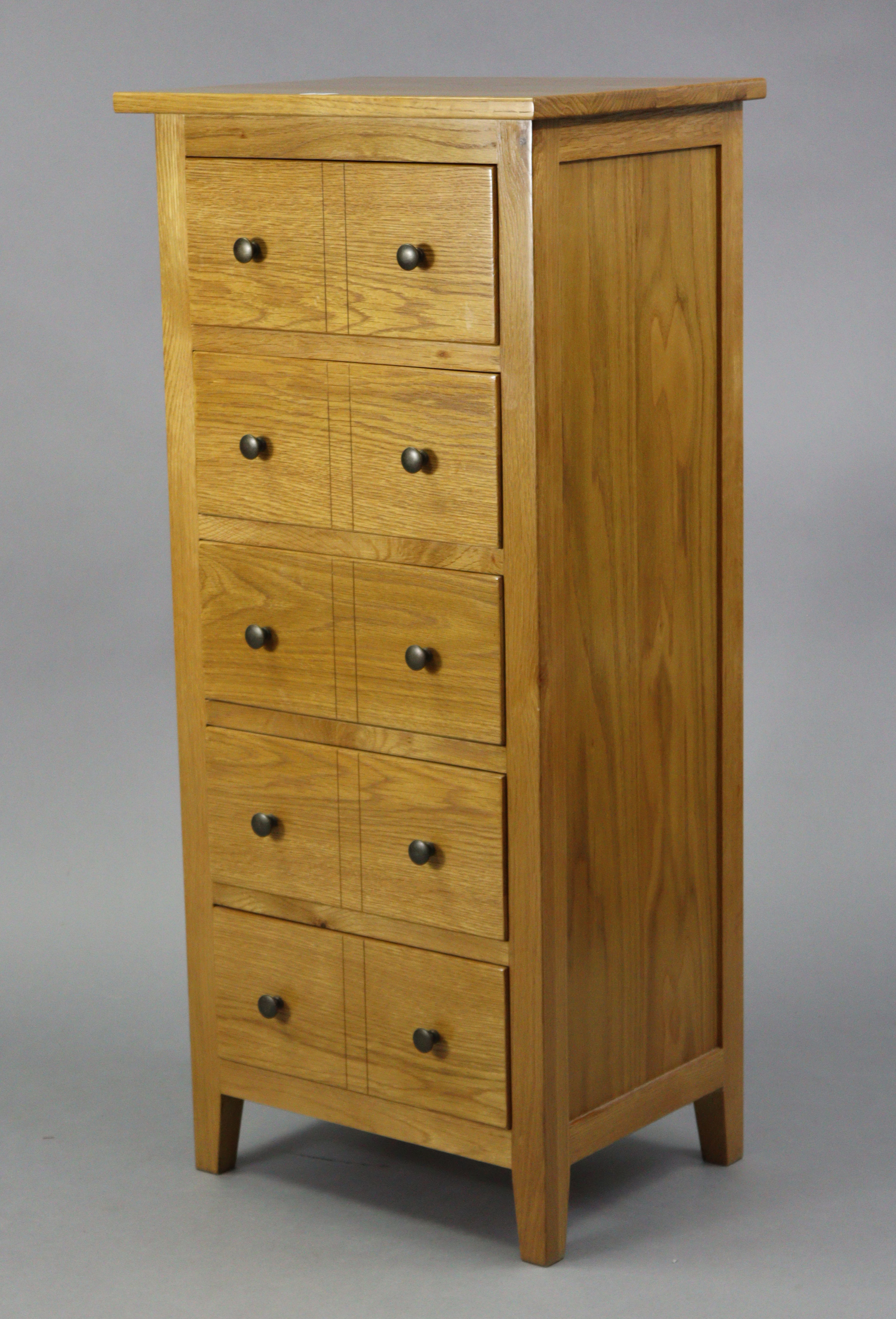 A modern light oak small upright chest fitted five long drawers, 19½” wide x 43½” high x 15” deep.