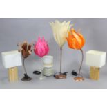 Four metal table lamps, each with floral-design shade; together with three other table lamps.