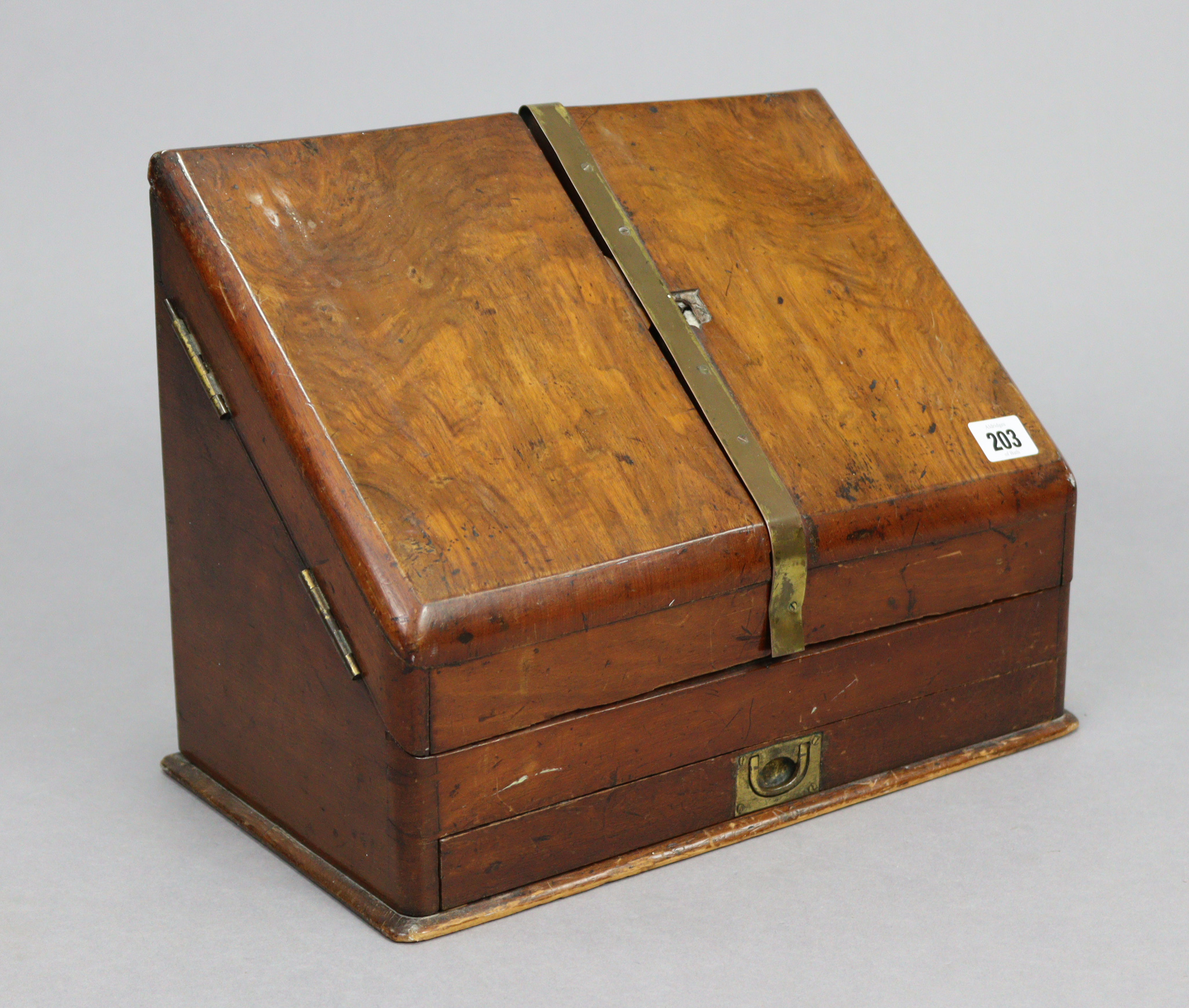 A late 19th century walnut sloping-front stationery cabinet, with fitted interior enclosed by pair