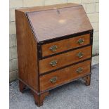 A late 19th century inlaid mahogany small bureau with fitted interior enclosed by fall-front above