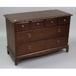 A Stag “Minstrel” mahogany-finish low chest fitted three short & two long drawers, & on shaped