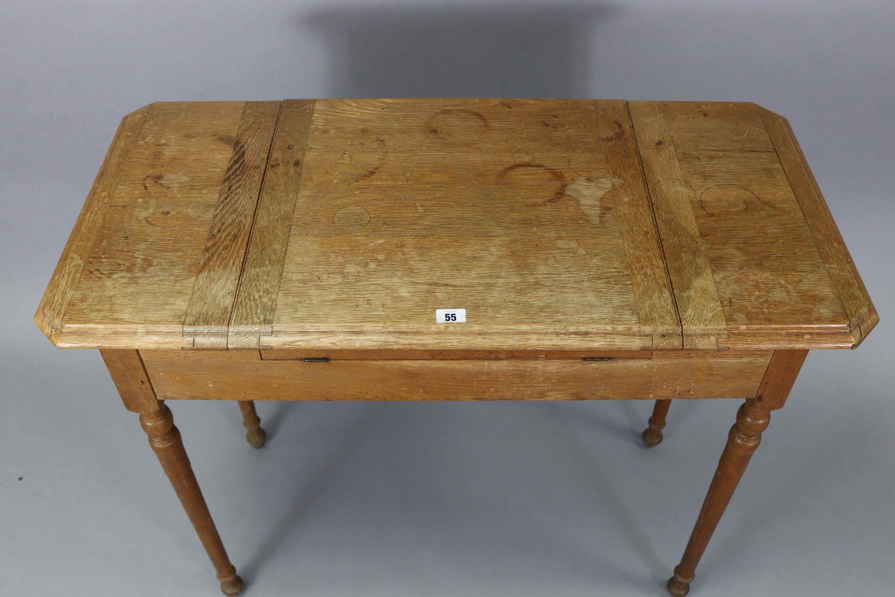 An Edwardian oak writing table with fitted interior enclosed by three hinged panels, & on turned - Image 7 of 7