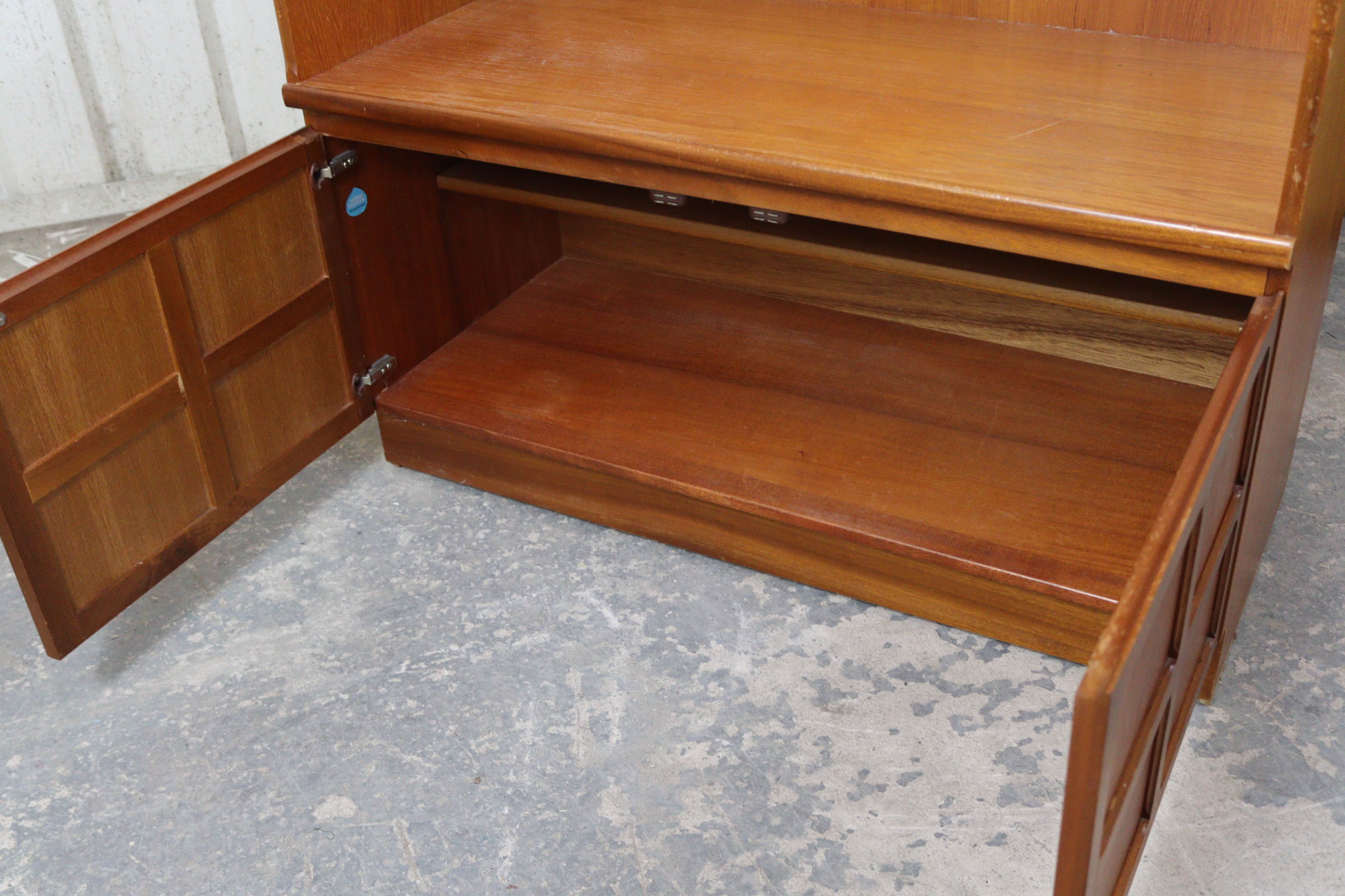 A Nathan teak tall wall unit fitted two shelves above cupboard enclosed by a pair of panel doors, - Image 3 of 4