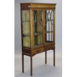An Edwardian inlaid-mahogany standing display cabinet with glazed sides, fitted two shelves enclosed