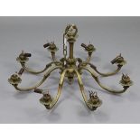 A brass eight-branch chandelier with scroll-arms, 30” wide x 15” high.