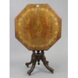 A late Victorian centre table with marquetry-inlaid foliate decoration to the octagonal tilt-